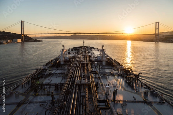 Fototapeta Oil product tanker is passing through Bousphorus strait when it sunset.