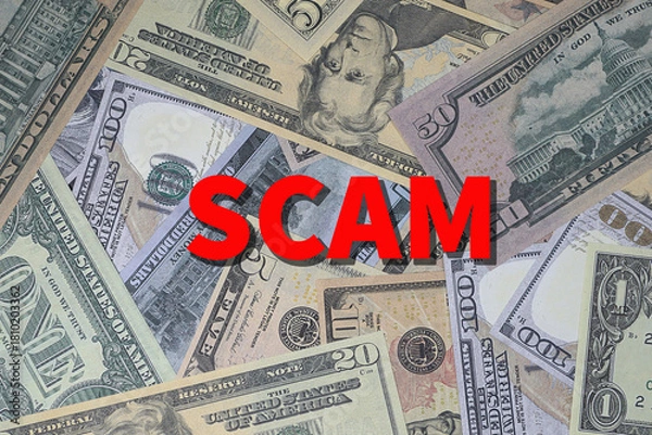 Obraz Background of US currency overlaid with word SCAM in red
