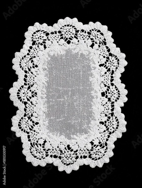 Fototapeta Rectangular white lace doily with scalloped border on black background