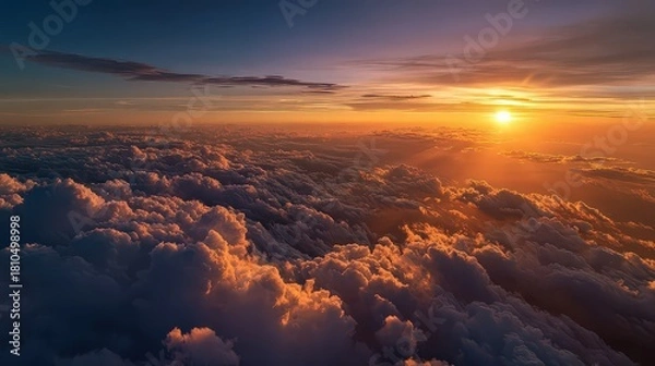 Fototapeta Aerial View Of Dramatic Sunset Over Cloudscape With Vibrant Orange Light Rays Shining Through Clouds And Dark Blue Sky Creating Breathtaking Scenery