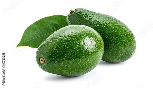 Fototapeta Two ripe avocados with a single leaf against a stark white background