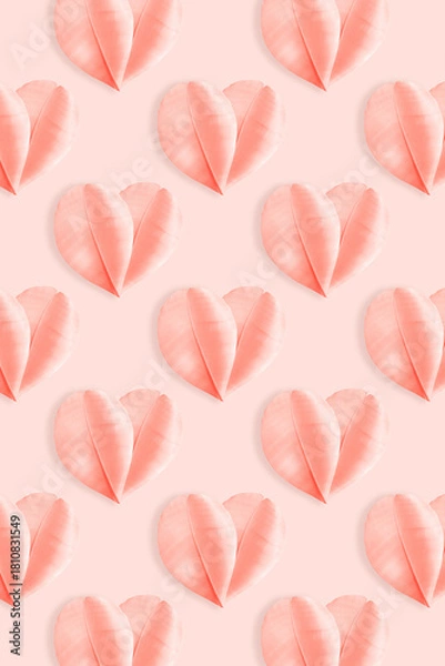 Fototapeta Minimalist pastel composition featuring delicate pink feathers arranged as heart shapes on soft rose background. Concept of love, tenderness, and romance, holiday greetings for Valentine Day, wedding.
