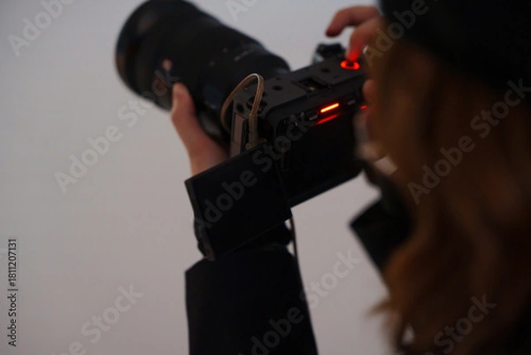 Fototapeta Finding the perfect shot while holding a camera