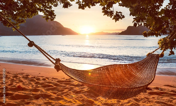 Obraz Traditional braided hammock in the shade at sunset on a tropical island