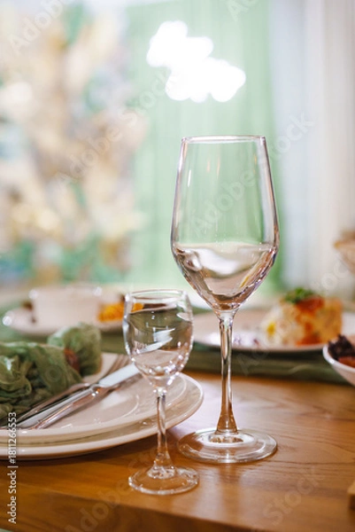 Fototapeta Elegant table setting with glasses and meal details