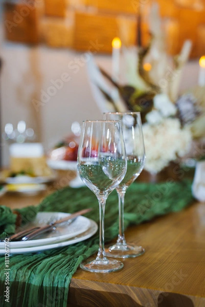 Fototapeta Elegant table setting with wine glasses and floral decor
