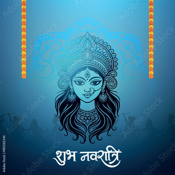 Obraz A stylized blue illustration of Goddess Durga's face with intricate details, framed by orange floral garlands, and a Shubh Navratri greeting below.