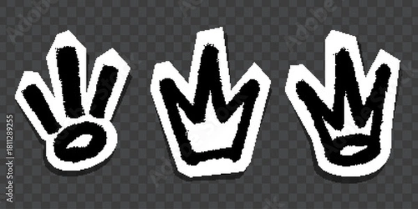 Fototapeta Graffiti-style black crown and symbol stickers with white outlines on dark background.