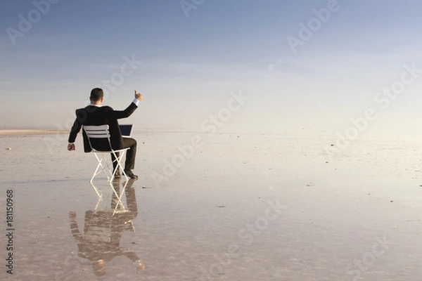Obraz Business man with laptop working on the beach