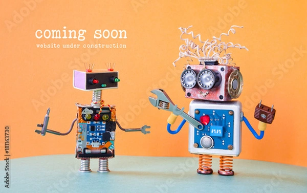 Obraz Web site under construction Coming Soon template page. Service robots maintenance with adjustable spanner screwdriver. orange background