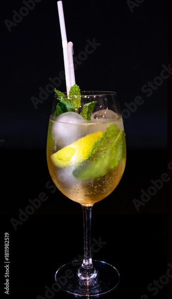 Fototapeta Imposing Gin Tonic or Spritz Cocktail with Mint Garnish in a Goblet Glass on Black Background