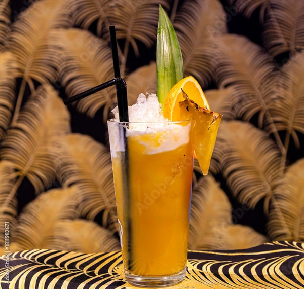 Fototapeta Vivid Tropical Highball Cocktail with Crushed Ice, Orange and Pineapple Garnish
