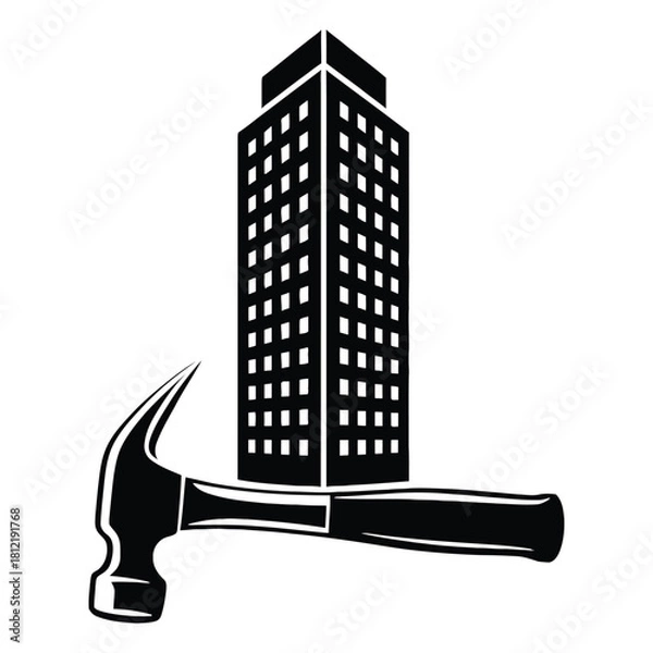 Fototapeta Construction and development concept showing a hammer in front of a building isolated on white background
