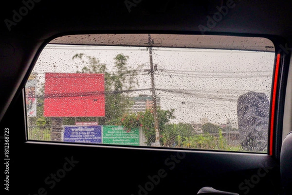 Obraz View from the inside of a working car,Car traffic jam,illuminated road during heavy rain and thunderstorms,highways in big cities,Rain drops on the car glass.