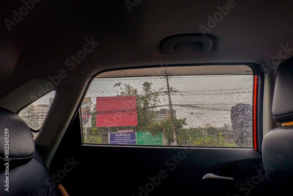 Obraz View from the inside of a working car,Car traffic jam,illuminated road during heavy rain and thunderstorms,highways in big cities,Rain drops on the car glass.