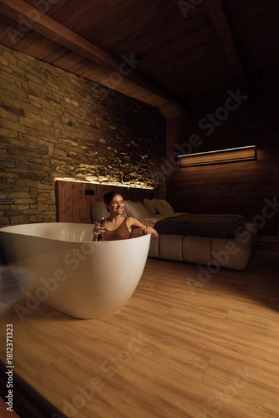 Obraz Relaxing evening in a cozy, stone-walled bathroom with wine