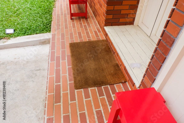 Obraz Welcome mat on red brick floor,Overhead of blank doormat at the front door,office or home,space for text.