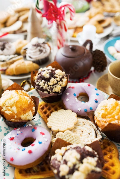 Fototapeta Variety of homemade pastry - donuts, muffins and bisquits on festive table