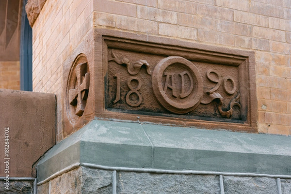 Fototapeta Historic stone carving showing the year 1890 on a building corner in an urban setting