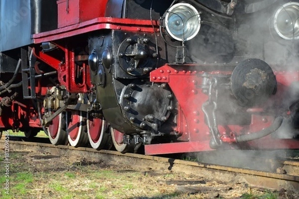 Fototapeta front part of an old steam locomotive on the railway close-up