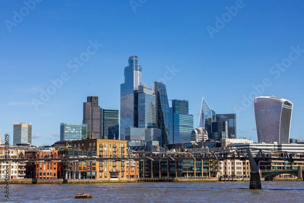 Obraz London skyline with modern skyscrapers, River Thames, and Millennium Bridge on a clear day.