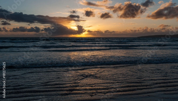 Fototapeta Beach sunset and gentile ocean waves in golden light
