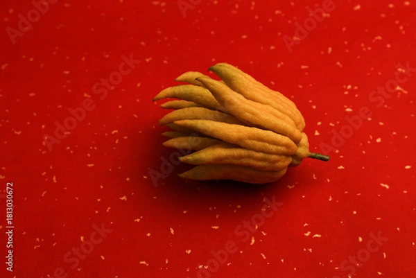 Fototapeta Red Background with Golden Dots, Auspicious Buddha's Hand Fruit