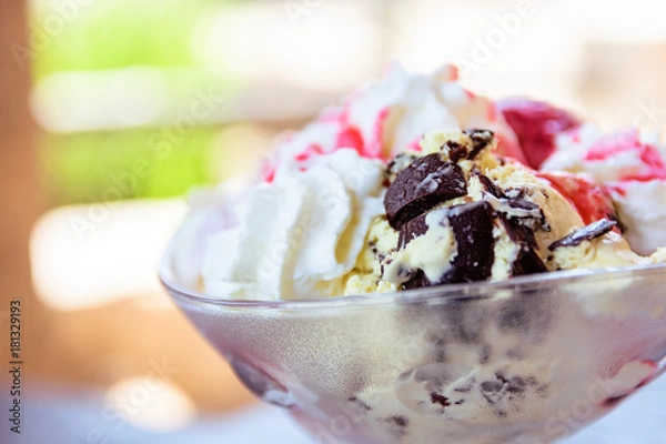 Fototapeta Vanilla Ice Cream Sundae In Bowl With Sauce And Dark Chocolate