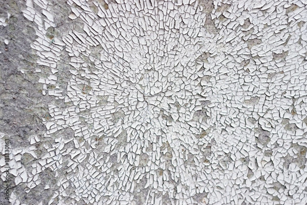 Fototapeta Texture Of Cracked And Crumbling White Paint In Circular Pattern On Cement Wall