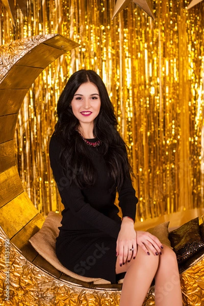 Obraz girl on holiday new year and christmas next to Christmas tree decorations and electric lights