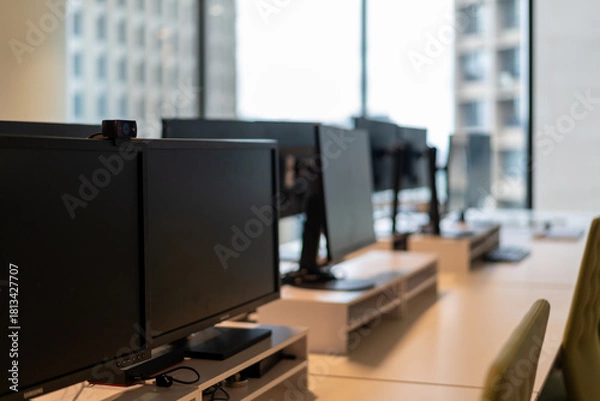 Fototapeta Modern office interior with sleek desks natural light inspiring productivity collaboration
