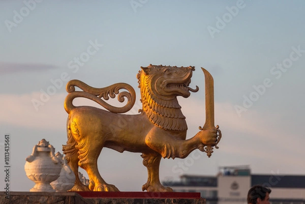 Fototapeta Golden Sinhalese lion statue at sunset in Colombo, Sri Lanka