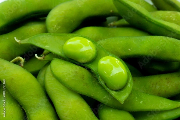 Fototapeta Close up of green edamame pods and beans on white plate