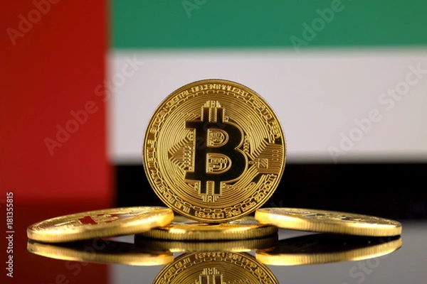 Obraz Physical version of Bitcoin (new virtual money) and United Arab Emirates Flag. Conceptual image for investors in cryptocurrency and Blockchain Technology in United Arab Emirates.