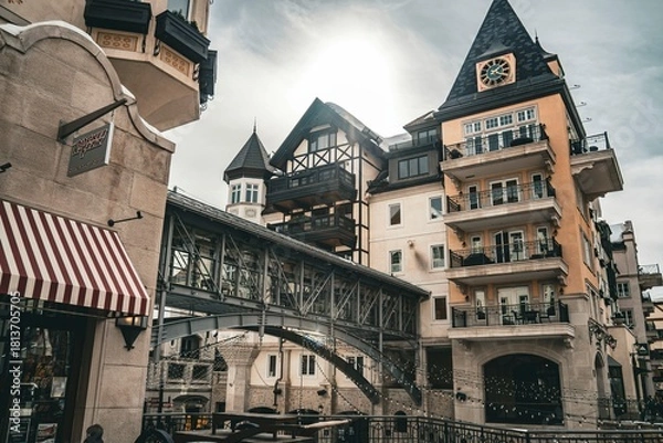 Fototapeta Historic architectural scene featuring traditional European buildings with timber framing and a covered bridge in a charming old town setting