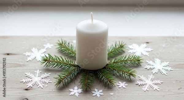 Fototapeta A Christmas candle with fir branches and snowflakes on a wooden table.