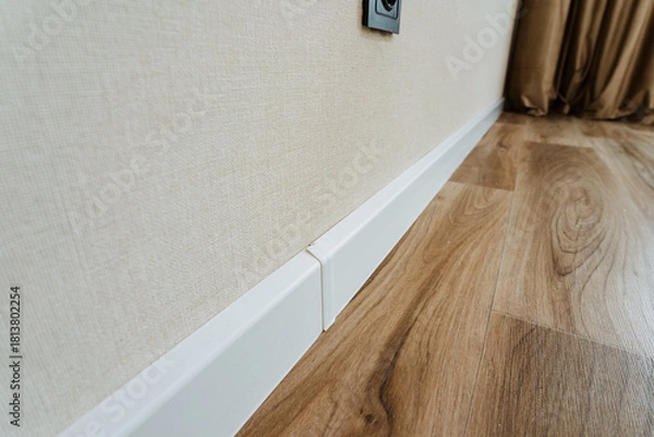 Fototapeta contemporary design showcasing minimal edges and coordinated color scheme, stylish white baseboard paired with natural light illuminating modern wooden flooring setup for lifestyle imagery