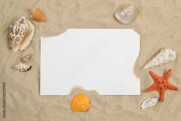 Fototapeta Seashells on sand with white paper in center
