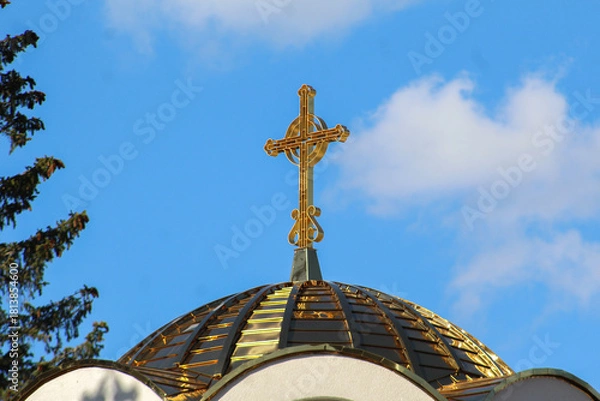 Obraz photo taken on June 3, 2025 on Jahorina, showing the golden dome and cross of the Serbian Orthodox Church of St. Basil the Great under a bright blue sky.