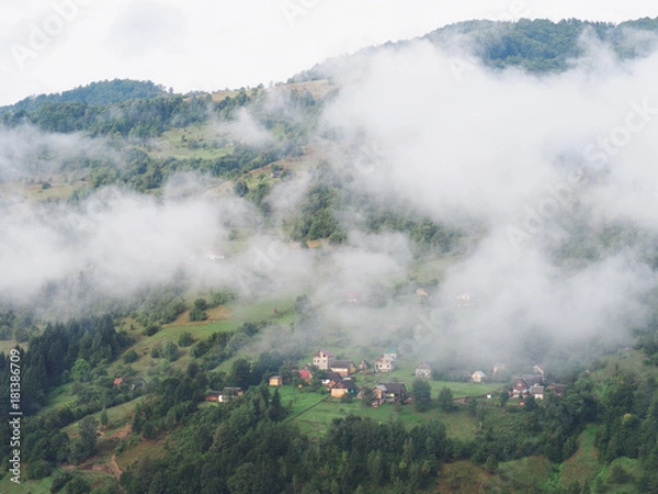 Fototapeta Fog at the village in the carpatian mountains