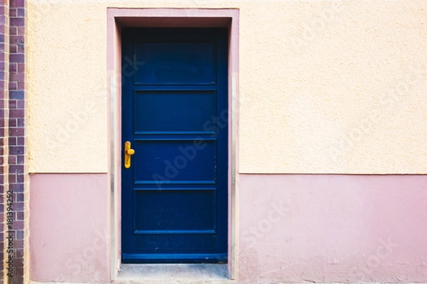 Fototapeta blue entrance door on orange building
