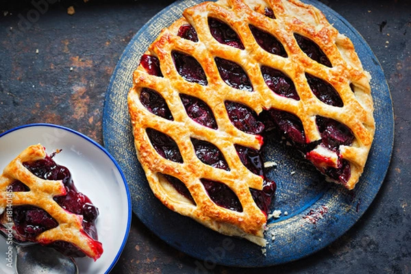 Fototapeta Lattice autumn fruit pie, with blackcurrant, blackberry, cherry compote in puff pastry pie 