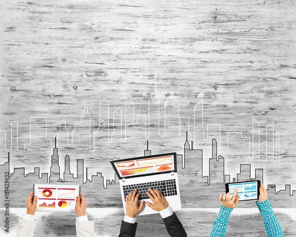 Obraz Top view of businesspeople sitting at table and using gadgets
