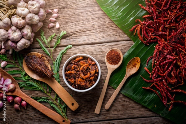 Fototapeta Thai tradition style spicy dipping chili paste and shrimp with spicy and herb for ingredient on wooden texture table