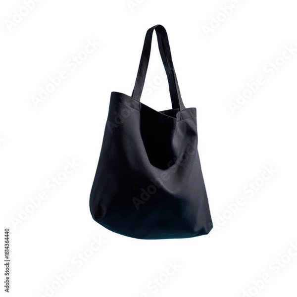 Fototapeta a plain black fabric tote bag floating in mid-air against a clean light blue background, shaped naturally as if being worn over the shoulder by an invisible person.