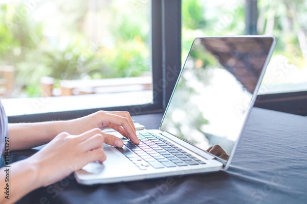 Fototapeta Business woman hand working with a laptop computer in the office.