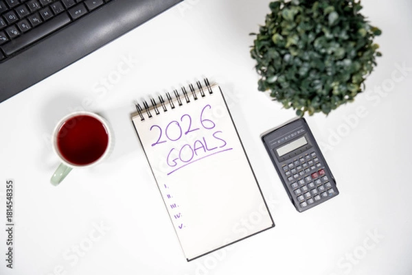 Fototapeta Office desk with 2026 Goals notepad and a calculator. Concept of financial freedom, savings, investment strategy, and economic planning for the new year.