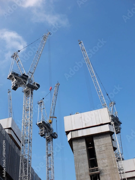 Obraz construction cranes working in a large development site with concrete large structure
