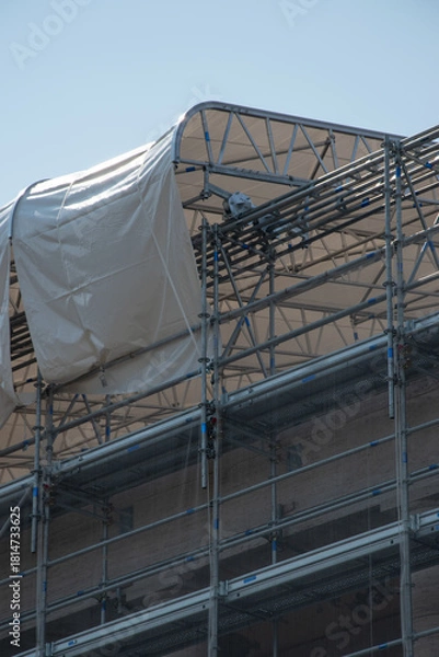 Fototapeta Scaffolding on the roof of a construction site to protect workers from the sun's rays and heat, Rome, Italy.