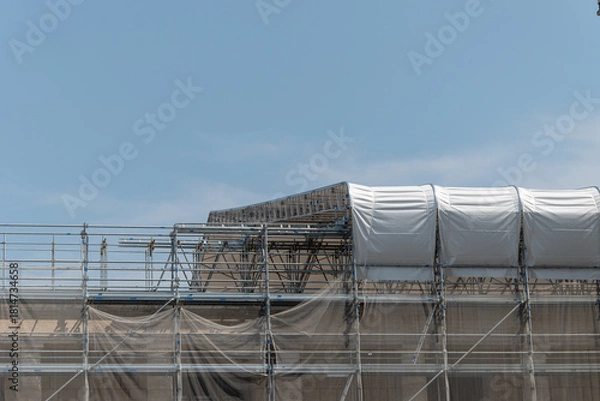 Fototapeta Scaffolding on the roof of a construction site to protect workers from the sun's rays and heat, Rome, Italy.